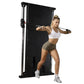 Woman using black wall-mounted cable pulley gym system with dual stacks, performing chest fly exercise with resistance cables