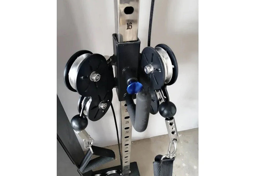 Black and silver dual pulley cable machine with metal frame, two black pulleys with white spools, blue adjustment knob, and c