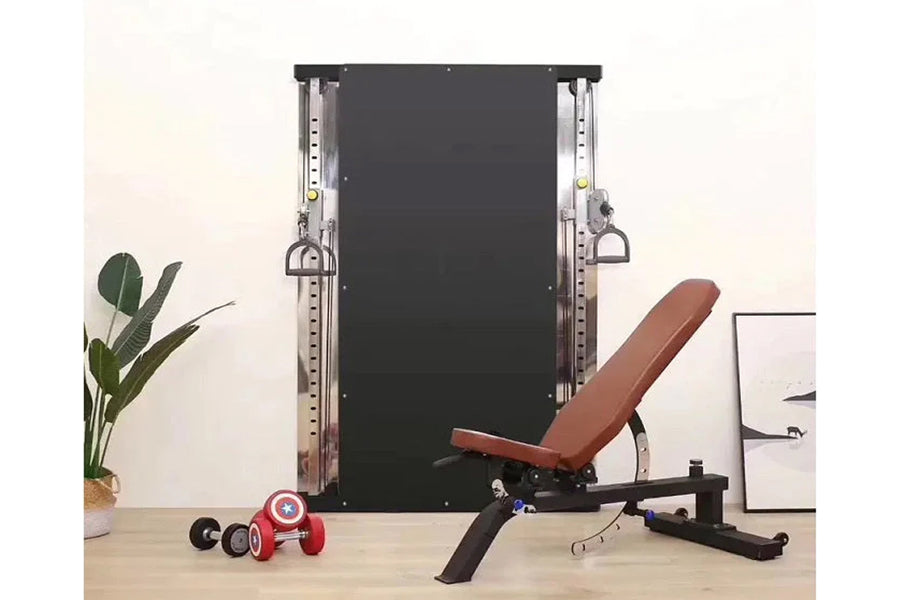 Warrior Wall Mounted Cable Pulley Home Gym System with two weight stacks, brown adjustable weight bench, and dumbbells on woo