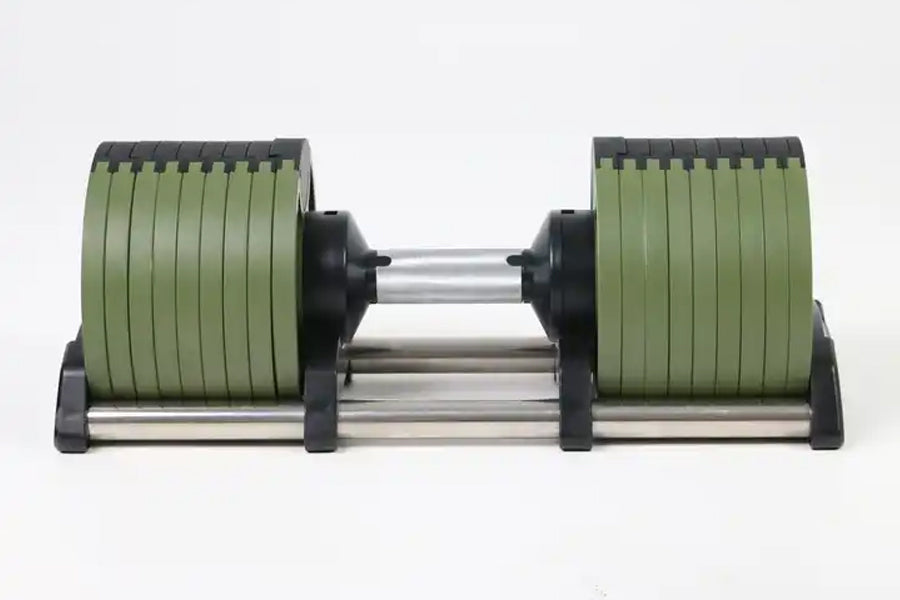 Adjustable dumbbell with green rubberized plates and black caps on silver steel bar, flat lay on white background