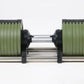 Adjustable dumbbell with green weight plates and black ends connected by chrome handle, shown on white background