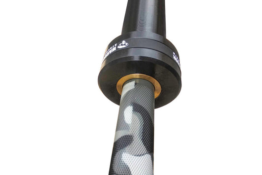 Warrior 6-bearing barbell with black cerakote sleeves and gray camouflage pattern shaft, gold collar rings