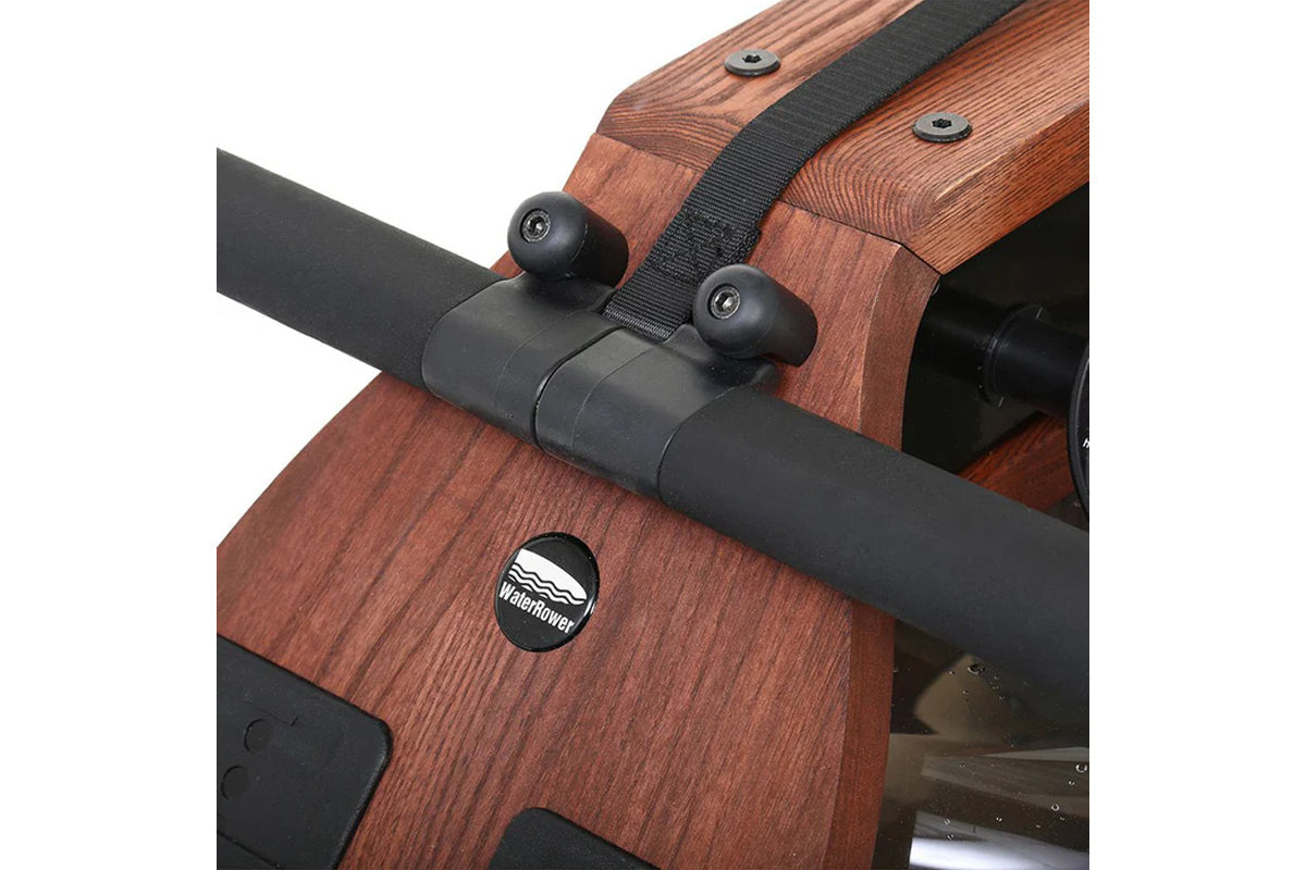 WaterRower Club rowing machine with wood frame and black handle, detailed view of resistance mechanism and WaterRower logo