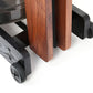 WaterRower Club rowing machine detail showing wooden frame with cherry finish legs and black rubber caster wheels on white ba