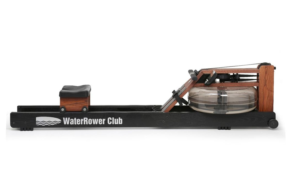WaterRower Club rowing machine with black base, wood accents, and water resistance tank, side view on white background