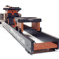 WaterRower Club rowing machine with orange wood frame, black rail, and water resistance tank on white background