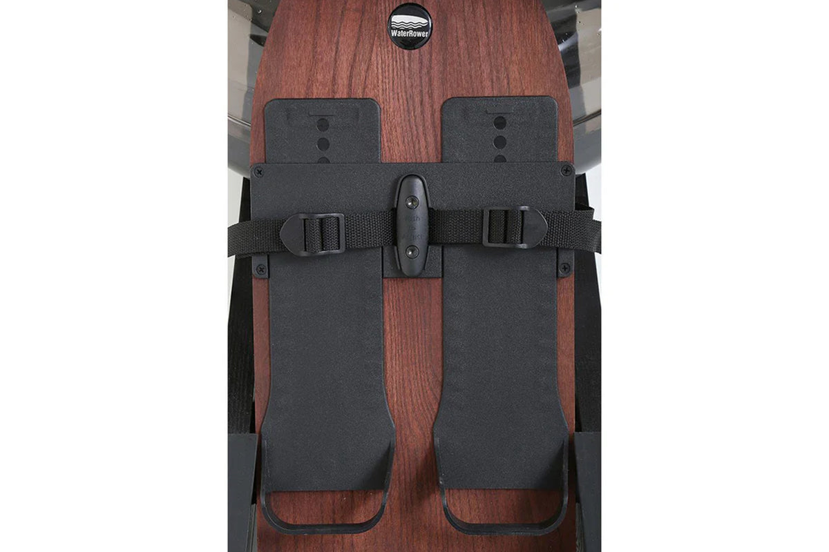 WaterRower Club rowing machine with reddish-brown wood frame and dark gray upholstered seat, viewed from above on white backg