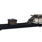 WaterRower Heritage rowing machine with black frame, wooden seat and footplate, and water resistance tank on white background