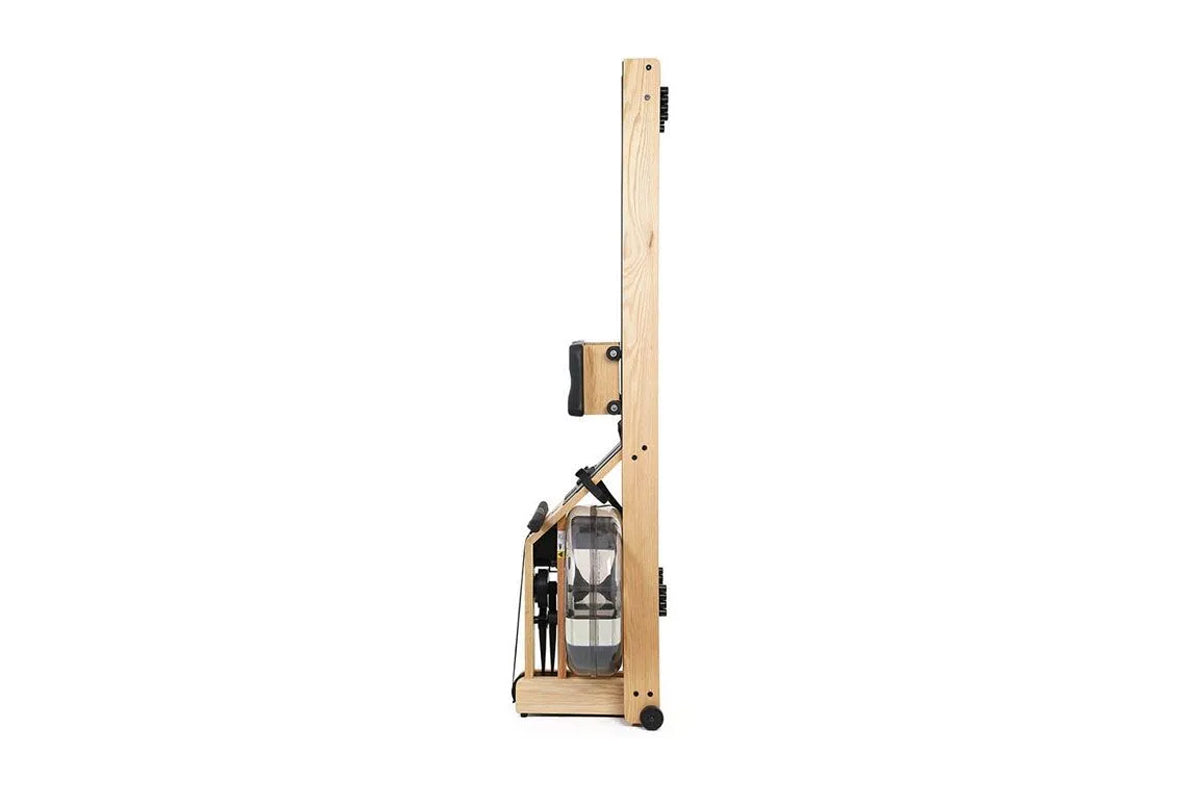 WaterRower Oak rowing machine with natural wood frame, water resistance tank, and black metal hardware on white background