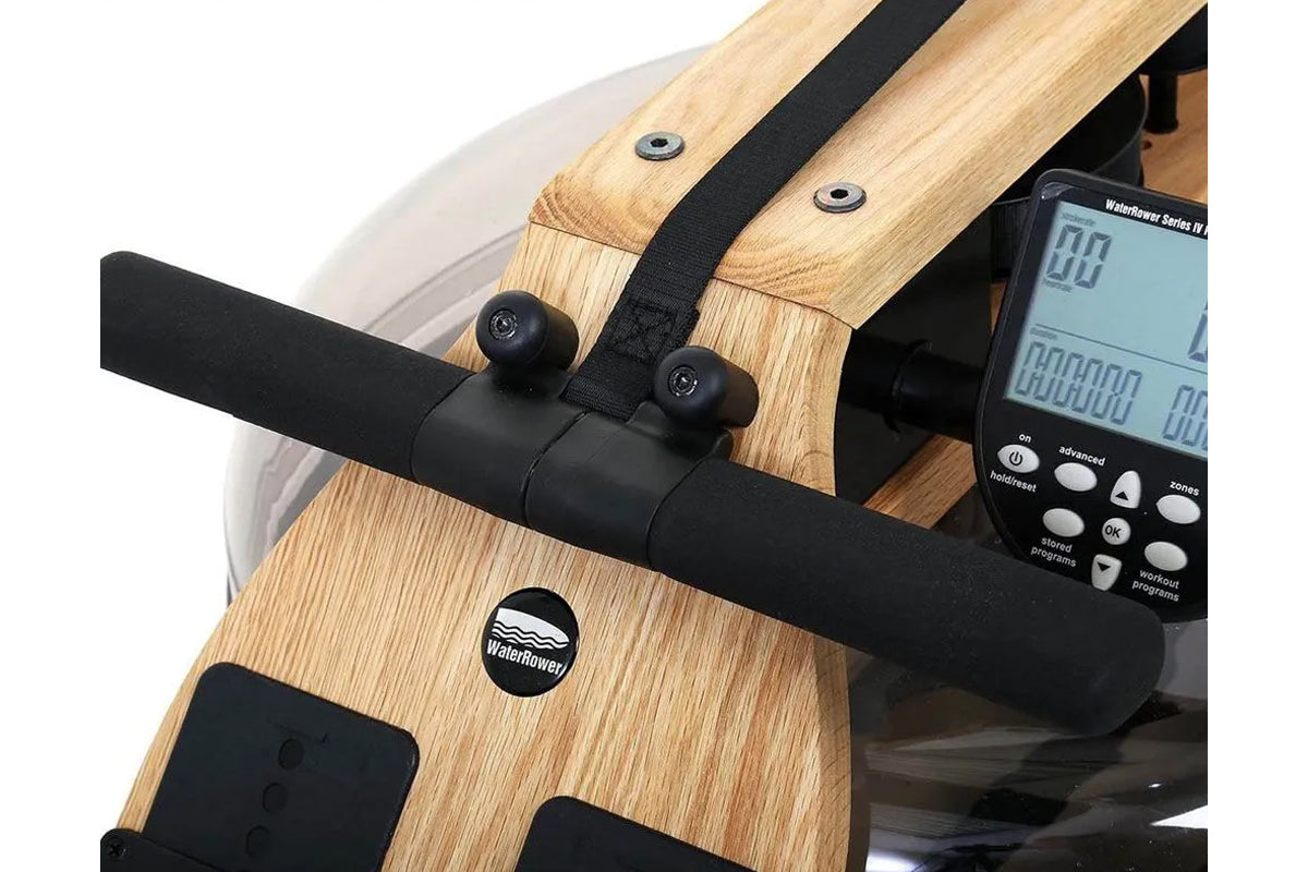 Water rowing machine with natural oak wood frame, black magnetic resistance unit, and digital performance monitor displaying 