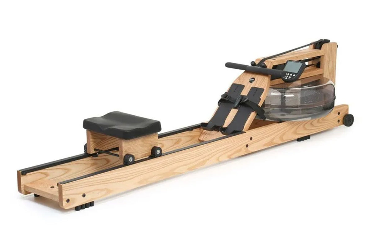 Wooden rowing machine with natural oak frame, black seat, footrest straps, and digital monitor on white background