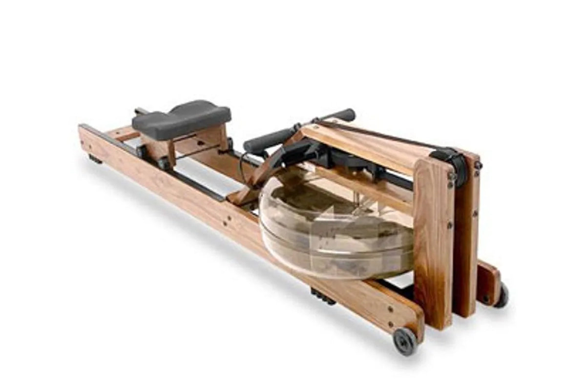 WaterRower oak rowing machine with natural wood frame, black padded seat, and water resistance chamber, shown fully assembled