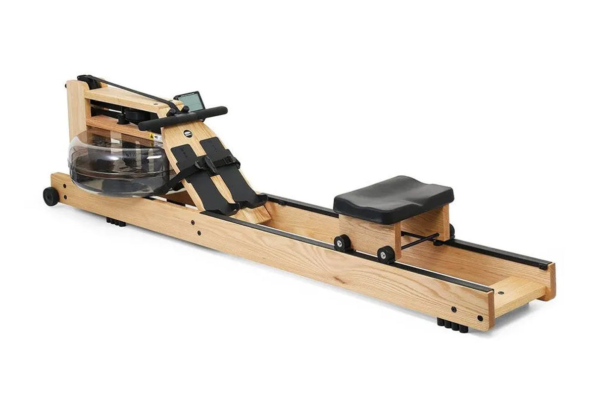 WaterRower rowing machine with natural oak wood frame, black straps and accents, water resistance tank, and black cushioned f