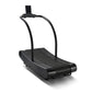 Black curved manual treadmill with curved running belt and dual handles on white background